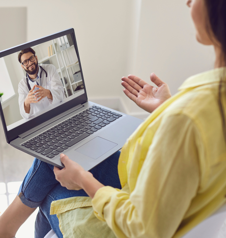 Woman on virtual care call with laptop